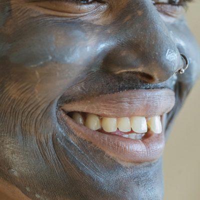 Black woman with purifying mask on face